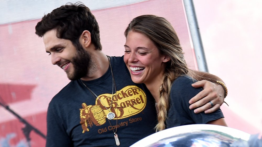 Thomas Rhett in a printed tee hugging Lauren Akins