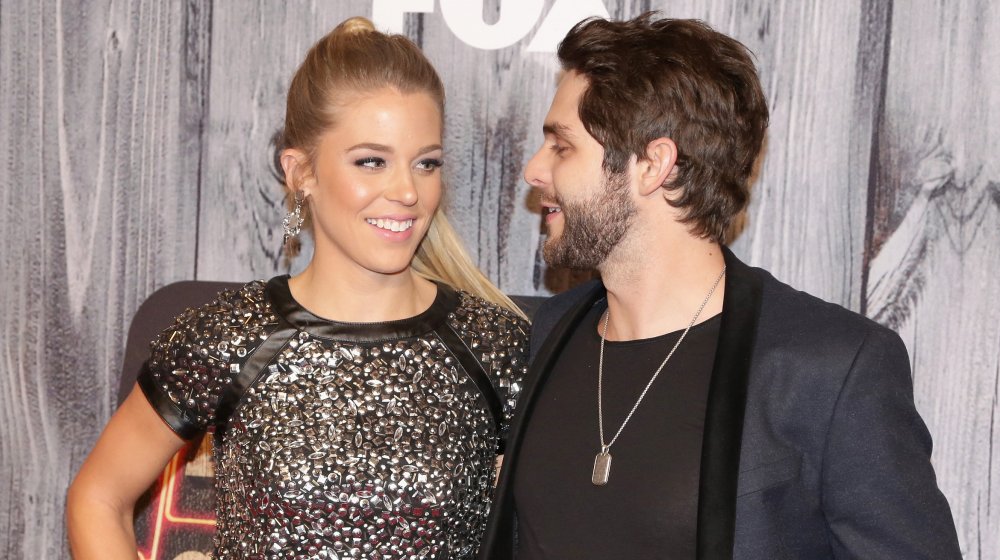 Lauren Akins in a black sequinned top next to Thomas Rhett