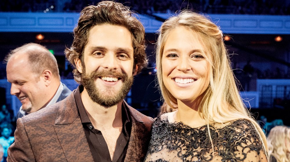Thomas Rhett arm in arm with pregnant Lauren Akins