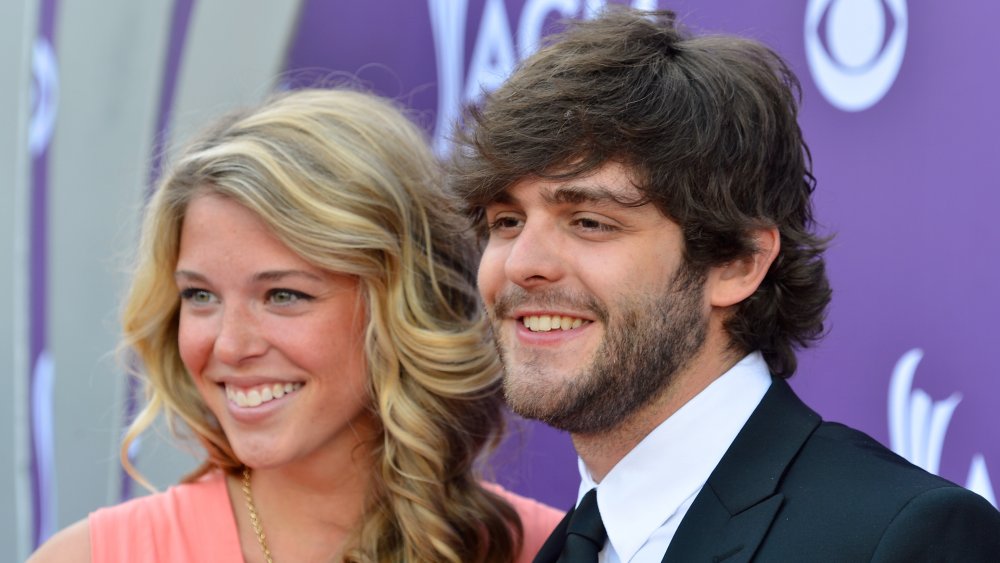 Lauren Akins with blonde hair next to a shaggy-haired Thomas Rhett