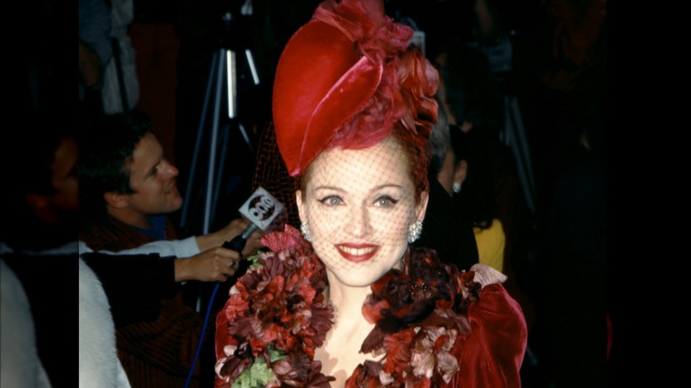 Madonna smiling wearing red hat