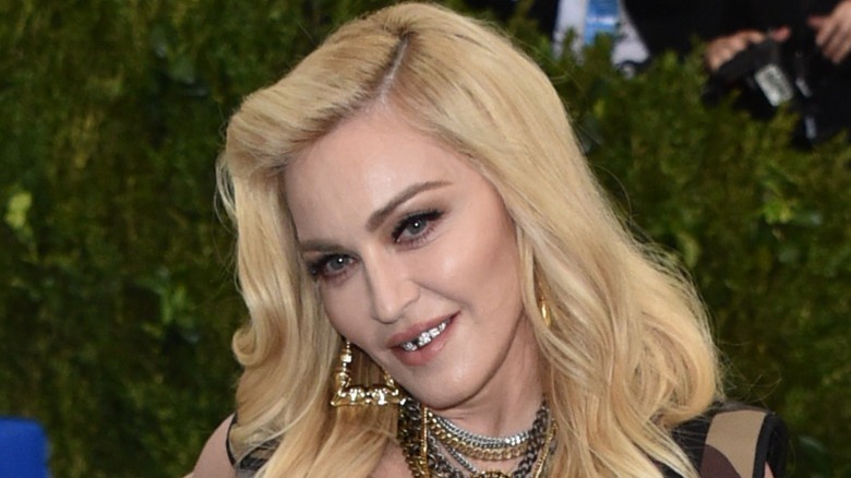 Madonna smiling wearing grills