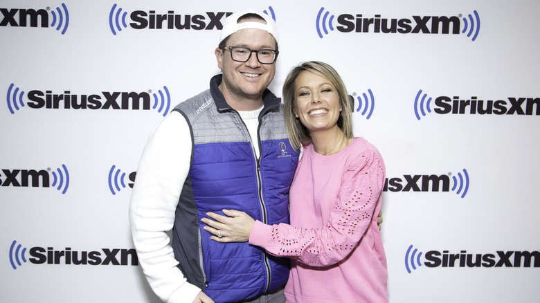 Dylan Dreyer smiles and places her hand on Brian Fichera's stomach while visiting SiriusXM Studios.