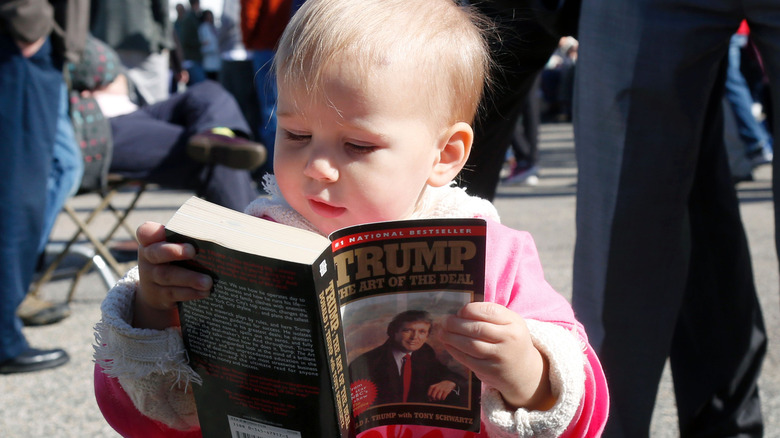 Baby reading The Art of the Deal