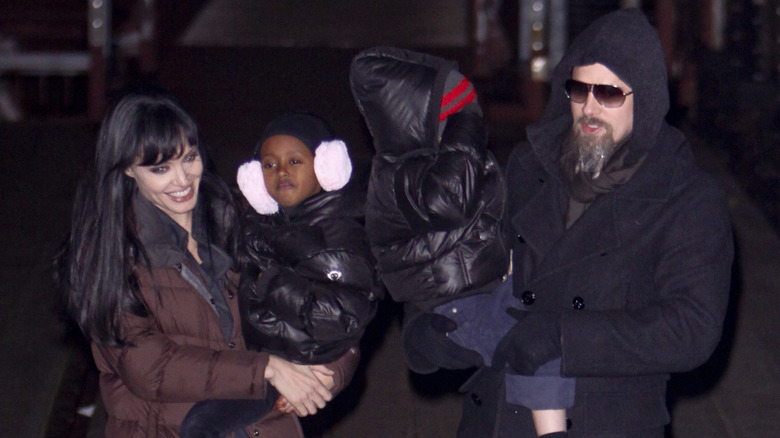 Angelina Jolie, Brad Pitt holding kids