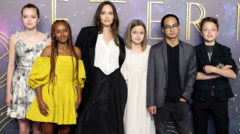 Angelina Jolie posing with five of her kids