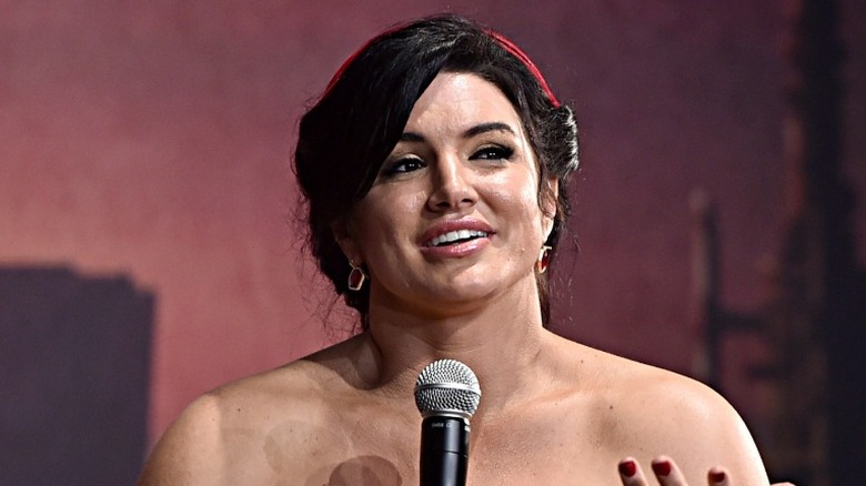 Gina Carano at a panel holding a microphone