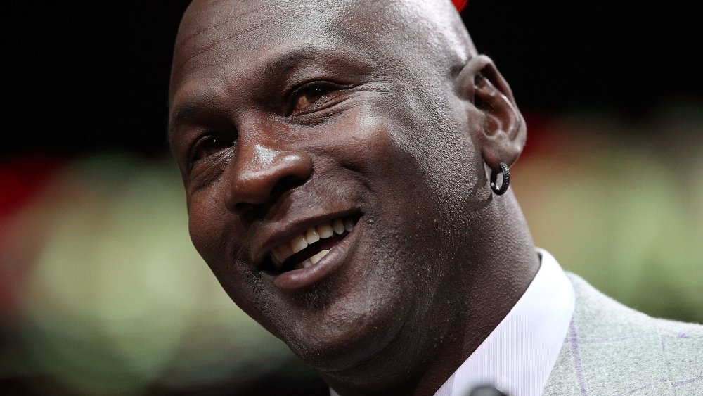 Michael Jordan smiling while tilting his head to the side
