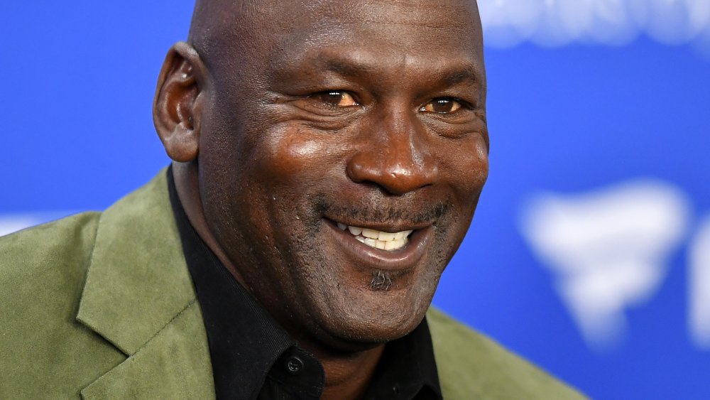 Michael Jordan smiling at a press conference before an NBA Paris game 