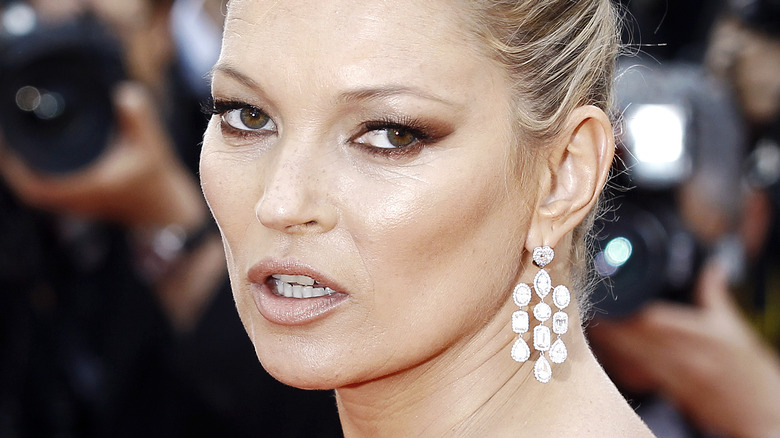 Kate Moss hair up with sparkling earrings