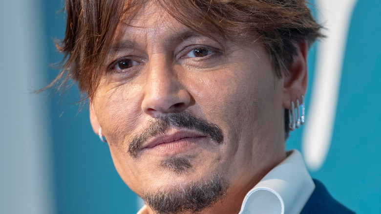 Johnny Depp wearing three earrings