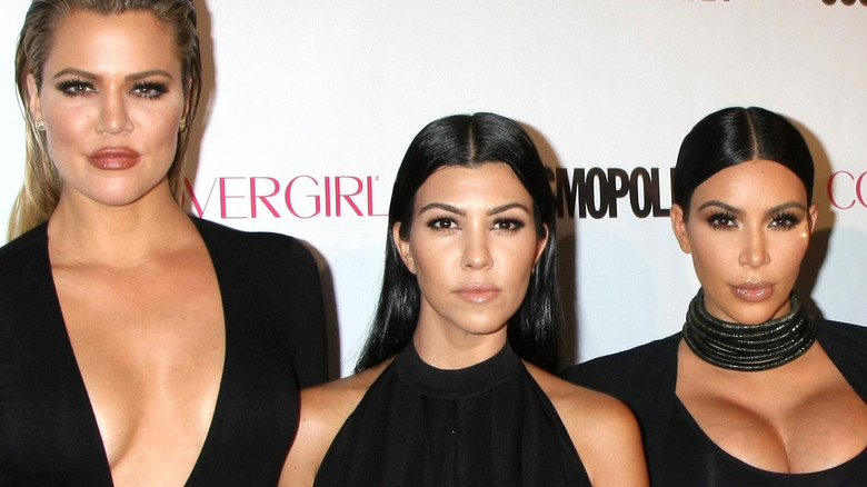 Khloé, Kourtney, and Kim Kardashian posing