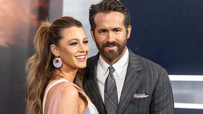 Blake Lively wearing dress by Versace and Ryan Reynolds attend The Adam Project
