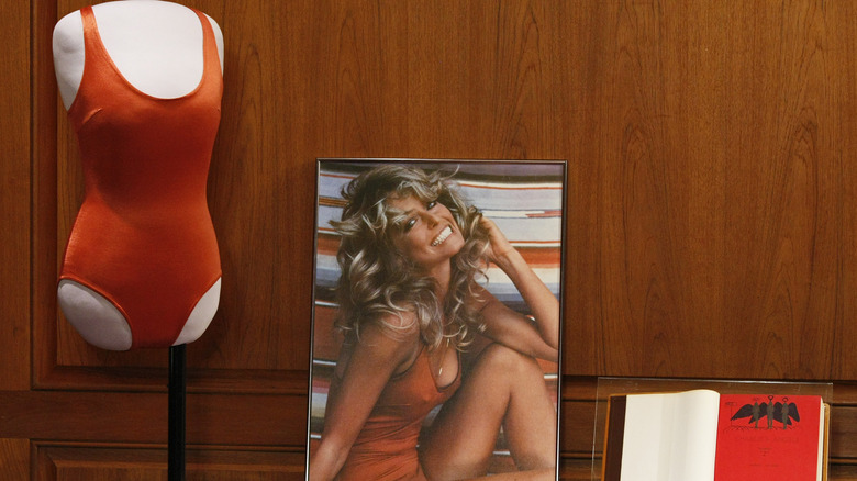 Farrah Fawcett's red bathing suit on a mannequin in a display with the poster that made her famous