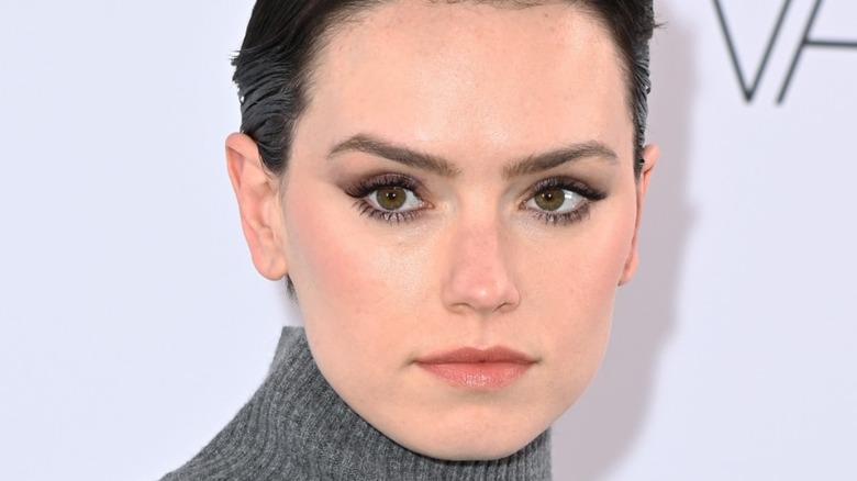 Daisy Ridley with a pixie cut and turtle neck 