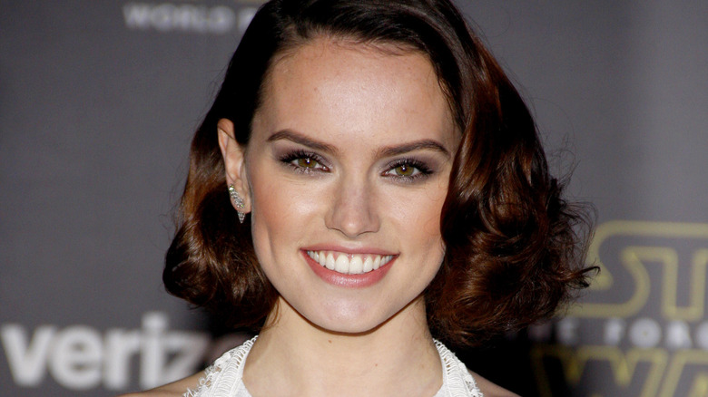 Daisy Ridley smiling with curled hair