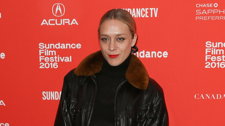 Chloe Sevigny wearing fur collar, smiling