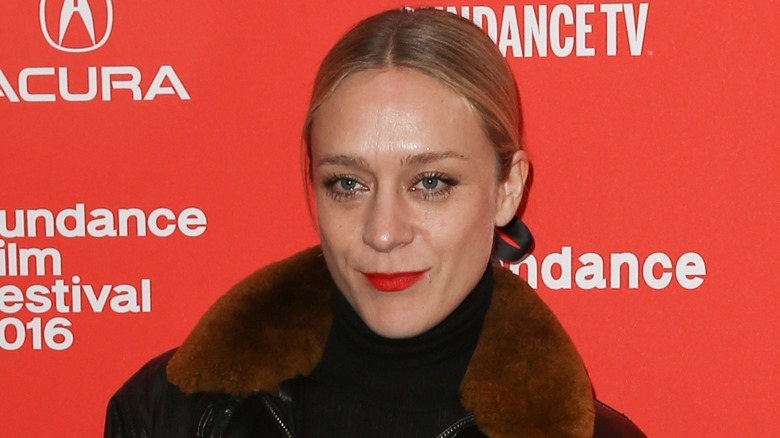 Chloe Sevigny wearing fur collar, smiling