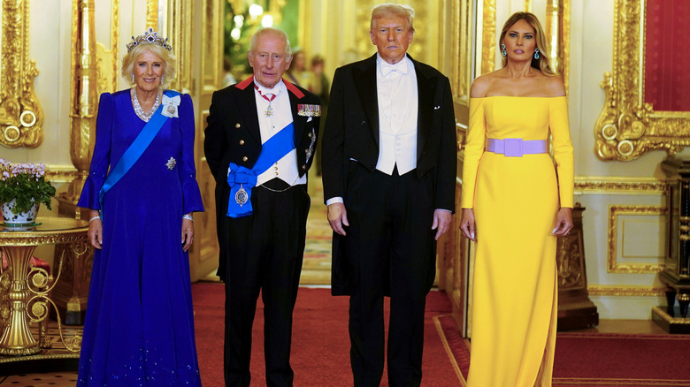 Melania Trump wearing a Carolina Herrera pink and yellow dress alongside President Donald Trump, King Charles III, and Queen Camilla