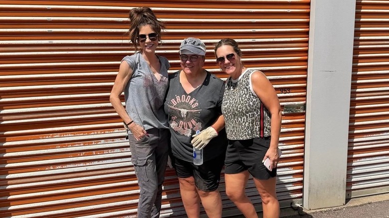 Kristi Noem posing with friends in front of a storage unit.