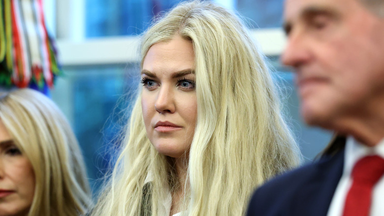 Erika Kirk looking intense with frizzy hair in the Oval Office.