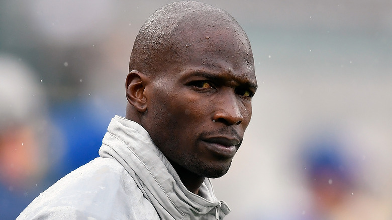 Chad Johnson wearing a blue and gray Adidas jacket 