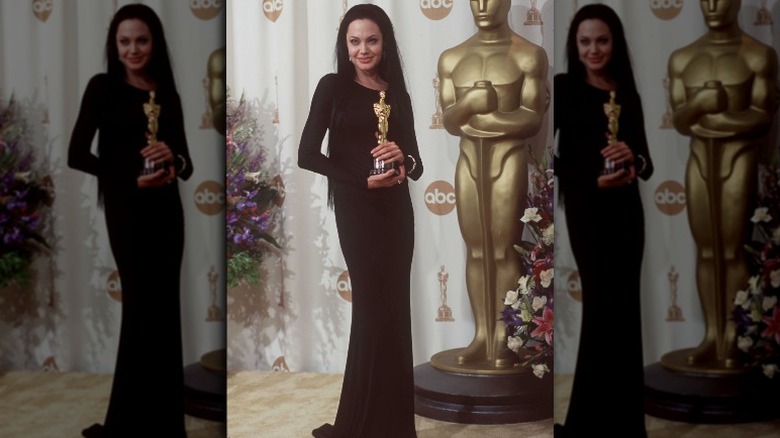 Angelina Jolie holding her Oscar