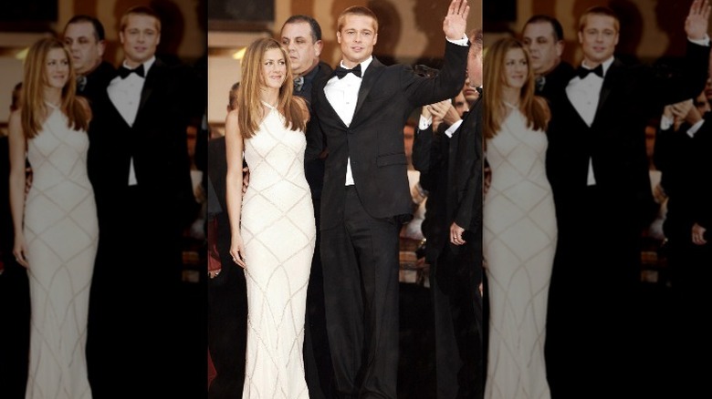 Jennifer Aniston and Brad Pitt smiling and waving on the red carpet