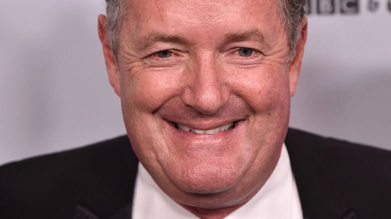 Piers Morgan smiling and looking at camera