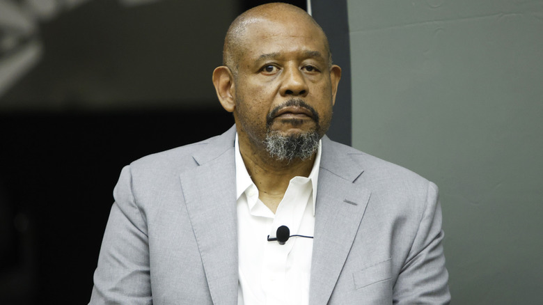Forest Whitaker, wearing a gray suit