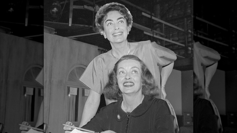 Bette Davis and Joan Crawford look over the script of the film What Ever Happened to Baby Jane?