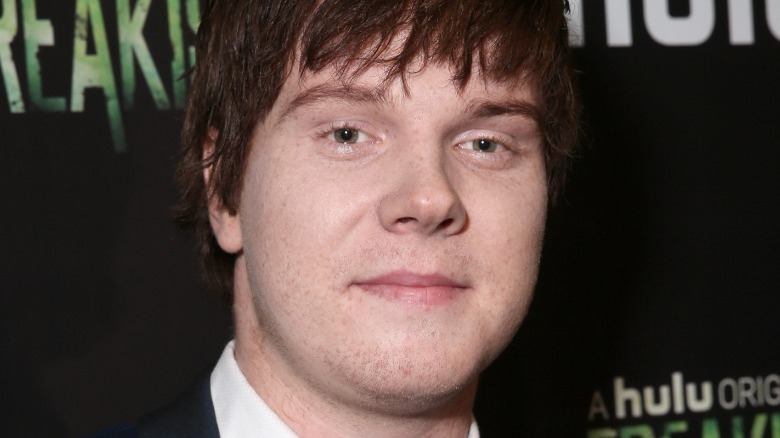 A closeup of Adam Hicks against black background