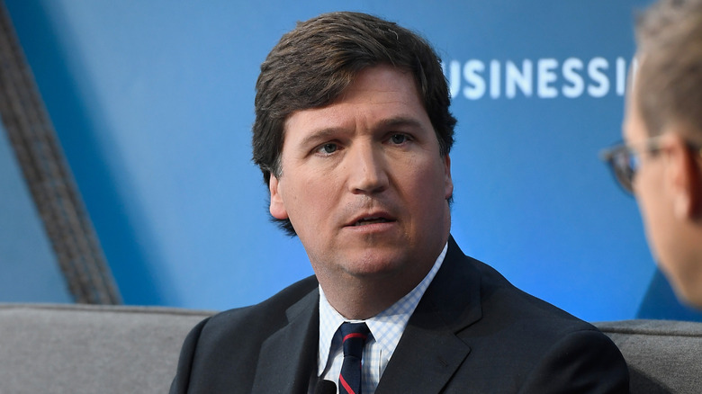 Tucker Carlson stares at an interview subject