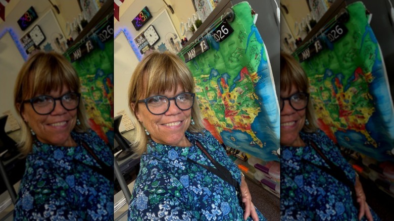 Amy Roloff poses in front of map in classroom