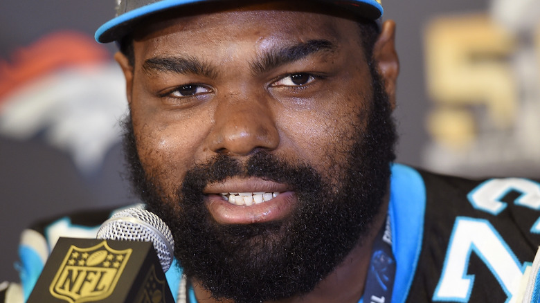 Michael Oher speaking into mic