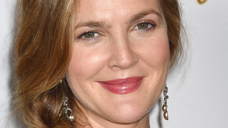 Drew Barrymore smiles in dark pink lipstick