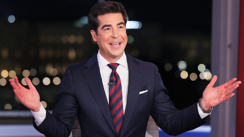 Jesse Watters gestures animatedly during a broadcast.