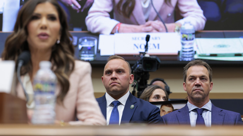Bryon Noem sitting behind Kristi Noem during her congressional hearing