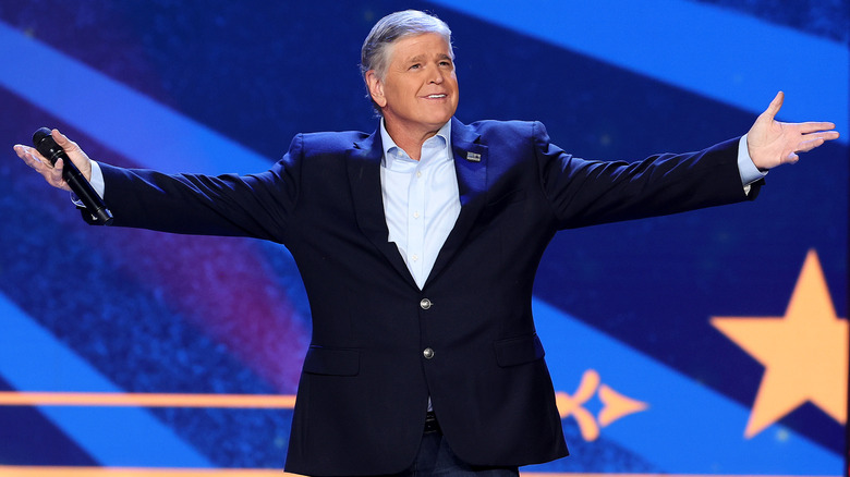 Sean Hannity poses dramatically on stage.