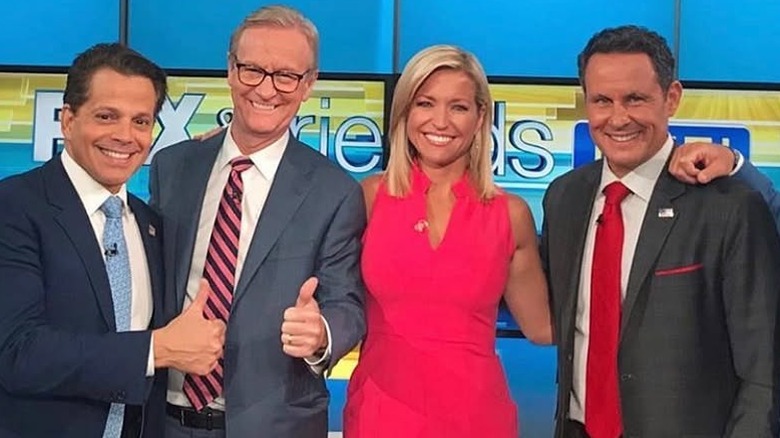 Ainsley Earhardt posing with Anthony Scaramucci and her co-hosts on the "Fox & Friends" set