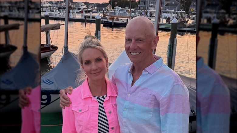 Dana Perino and Peter McMahon pose together in a harbor.