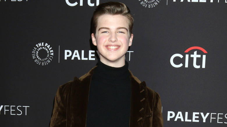 Iain Armitage smiling while posing on the red carpet at Paleyfest