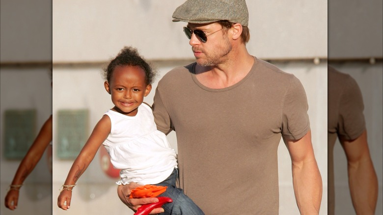 Zahara Jolie being held by Brad Pitt.