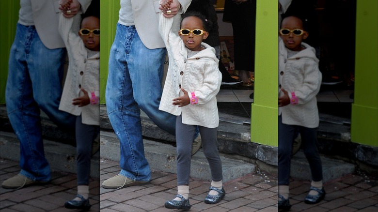 Zahara Jolie wears sunglasses with gold frames as she leaves a toy store.
