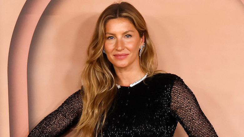 Gisele Bündchen posing in a black transparent outfit