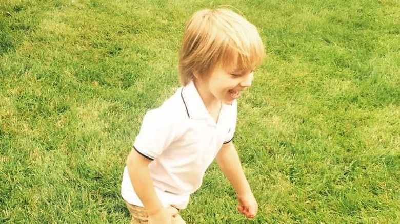 Little Duke Rancic gazes downward on grass