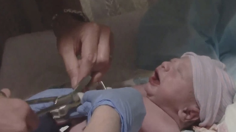 Newborn Duke Rancic cries as his father Bill Rancic cuts his umbilical cord
