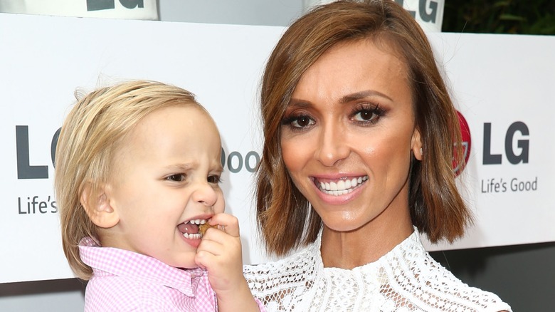 A young Duke Rancic makes a cheeky face while his mother Giuliana Rancic flashes a toothy smile