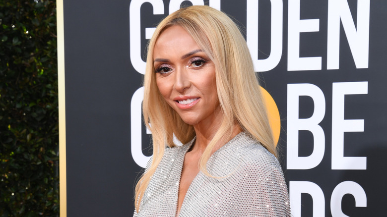 Giuliana Rancic with long platinum blonde hair wearing a silver sparkling gown