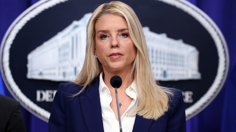 Pam Bondi standing in front of microphone